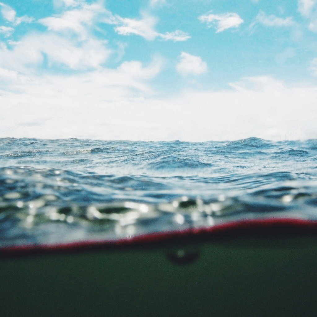 View of the ocean under a partly cloudy sky with waves