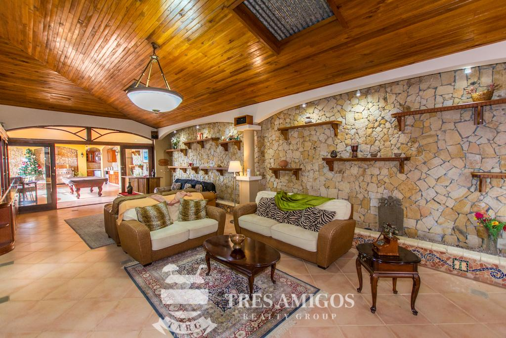 Spacious living room with wooden ceiling in a Papagayo villa.