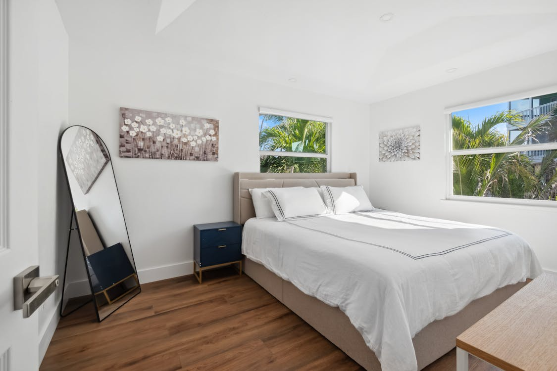 a bedroom with a full-length mirror.
